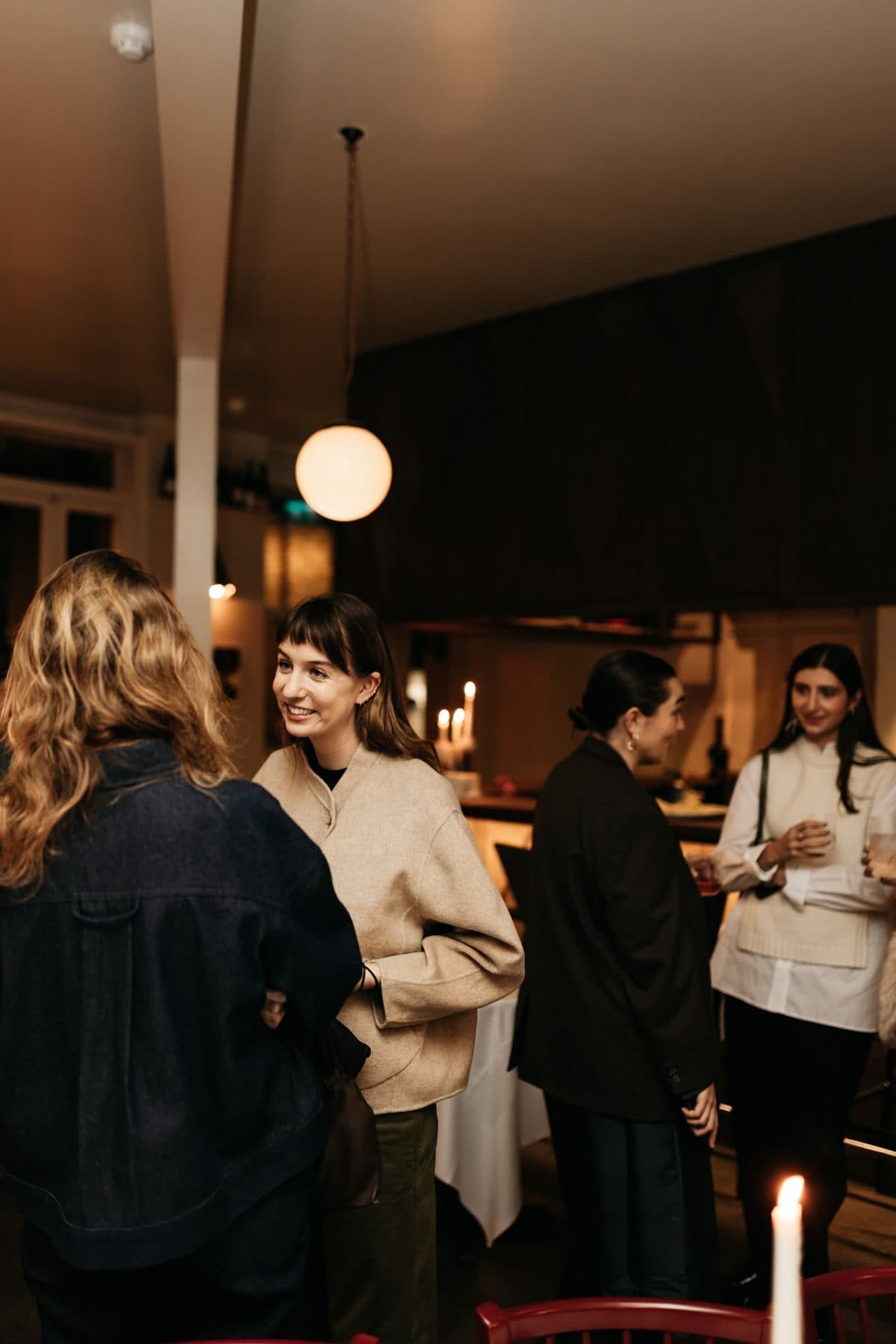 Guests mingling with drinks at a NOR Table brand event.