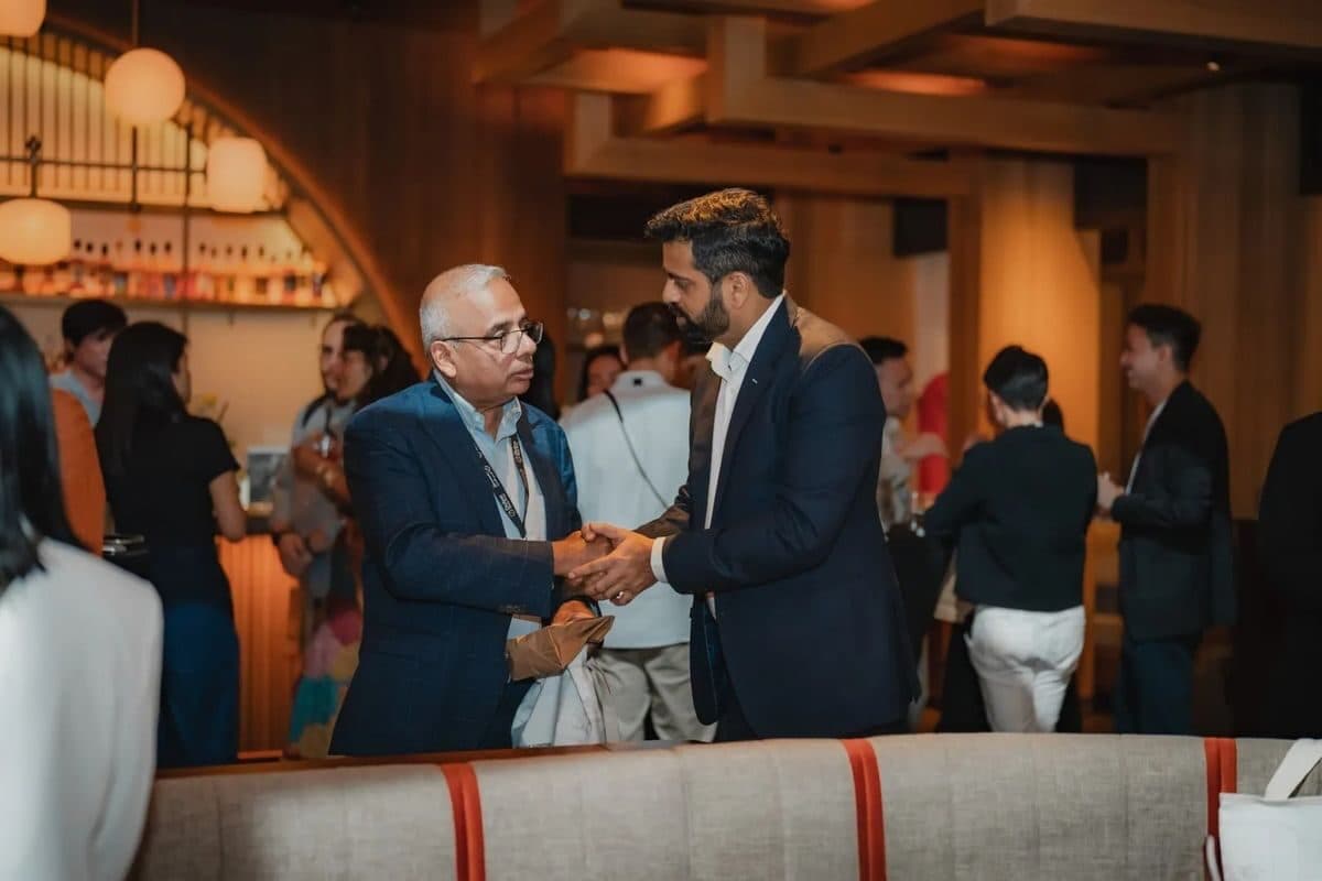 Guests shaking hands at a NOR Table corporate reception.