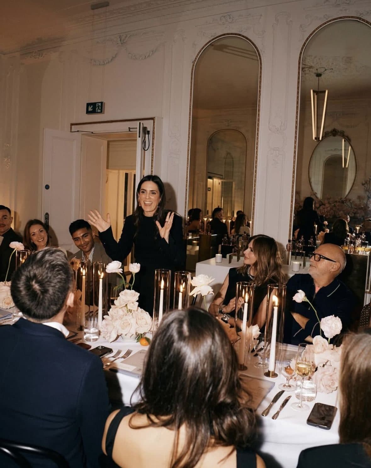 A host addressing guests at an intimate NOR Table dinner celebration.