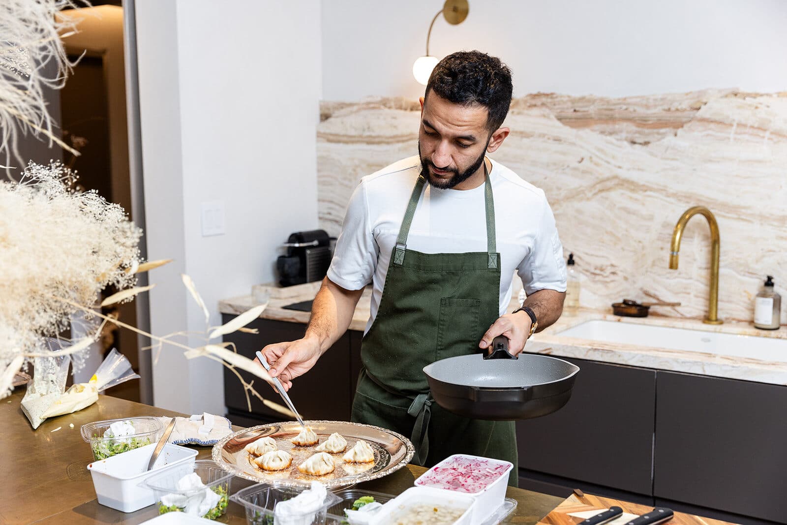 A chef testing plated dumplings during a Studio R&D session.