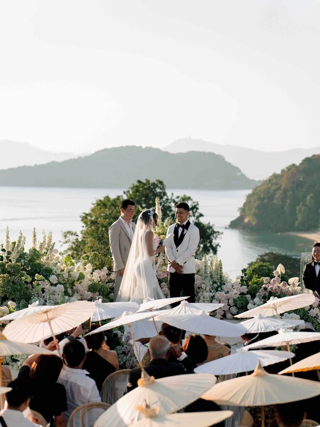 A couple exchanging vows at a coastal wedding ceremony.